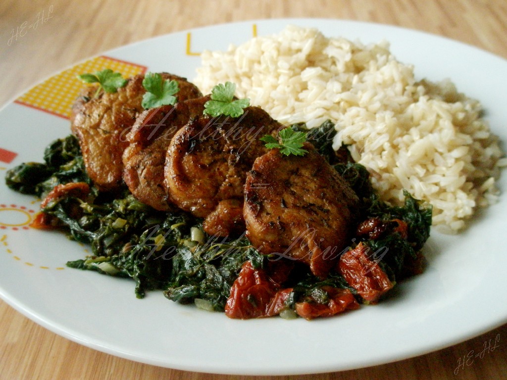 Stewed tenderloin on tomato spinach