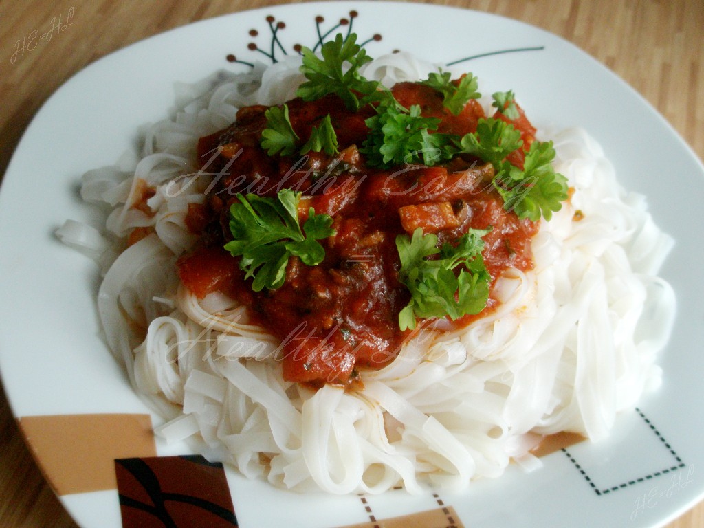 Rice pasta with tomato-mushroom sauce